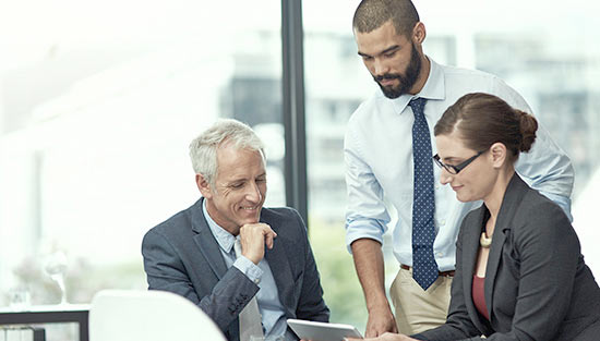 Business people at desk smiling